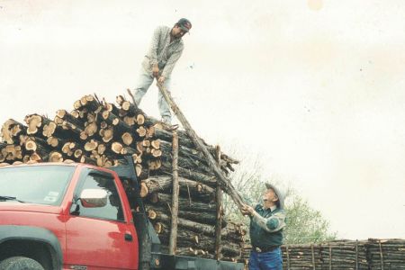 Jerry and one of his trusted cutters unloading posts on the yard